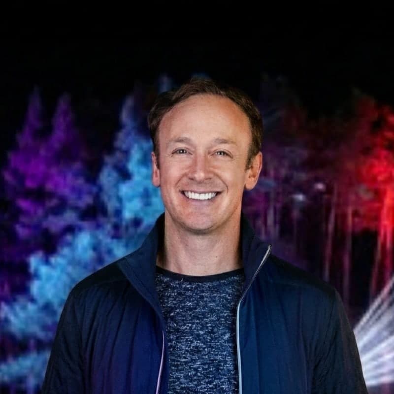 Jay Ozer smiling in a dark jacket